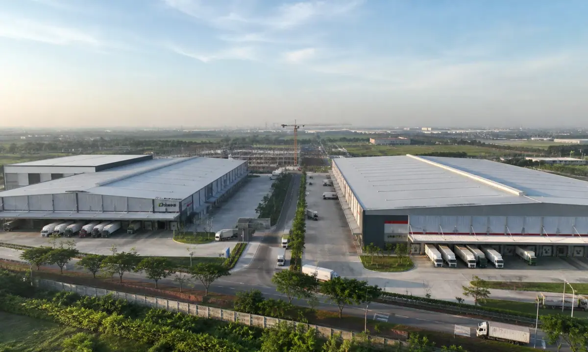 Editorial illustration of two modern logistics facilities connected to Greater Jakarta by a supply-chain route.