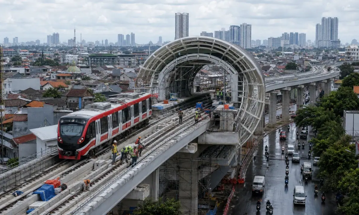 An elevated Jakarta light-rail extension under final construction above an active city corridor.